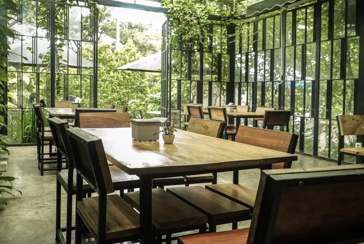 Garden-facing tables at Merak Kitchen in Bogor