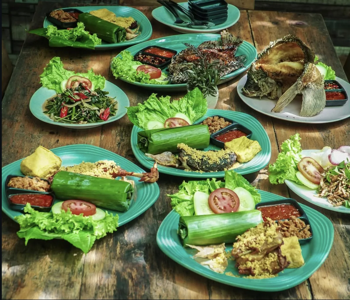 Sundanese dishes served on a shared table at Merak Kitchen